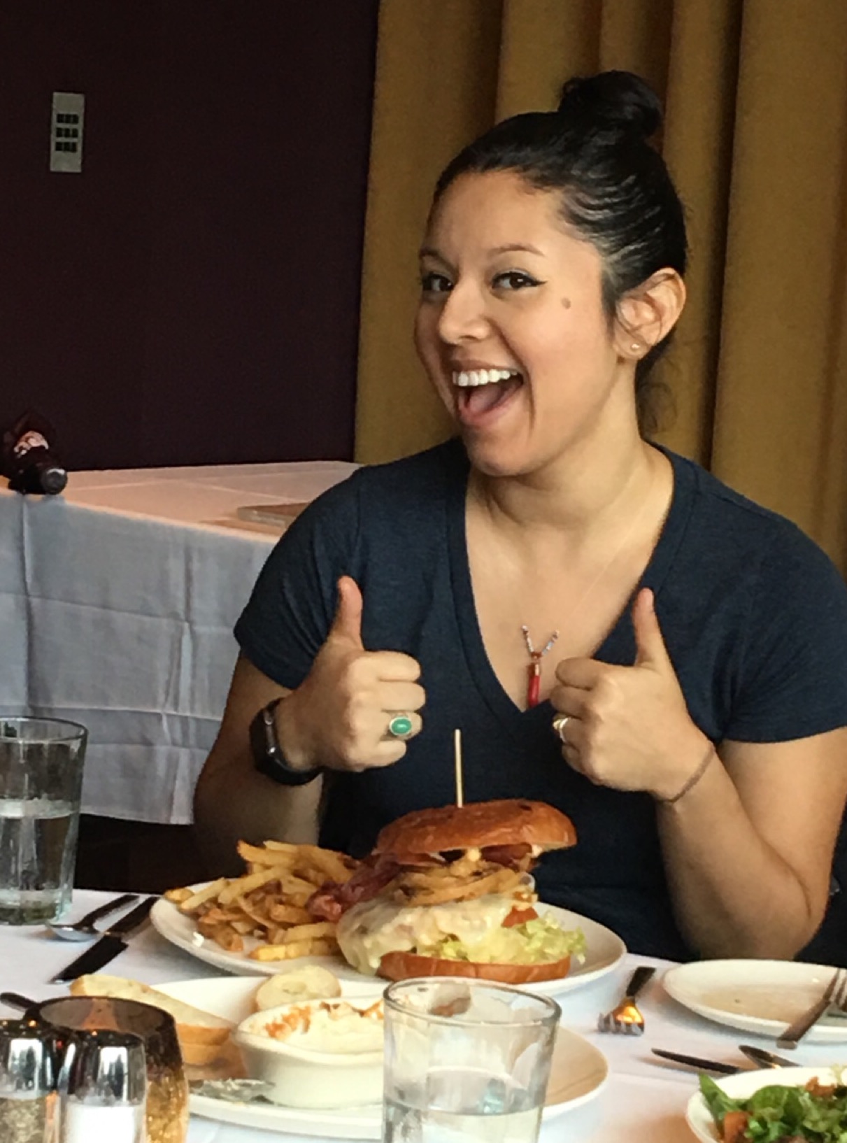 Student Catalina Duarte gives a thumbs up at the League for Innovation luncheon.