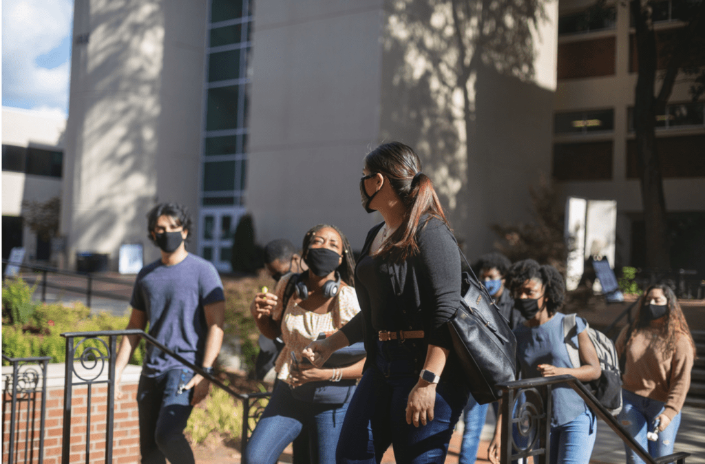 students walking with masks while on campus