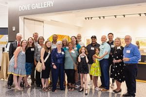 Large group of people standing in front of the Dove art gallery in Parr Center