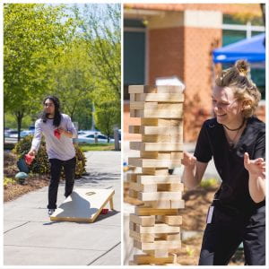 Student playing cornhole and another student smiling as she pulls a block from a tall jenga tower game.