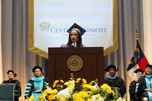 A student graduation speaker gives a speech at the podium.